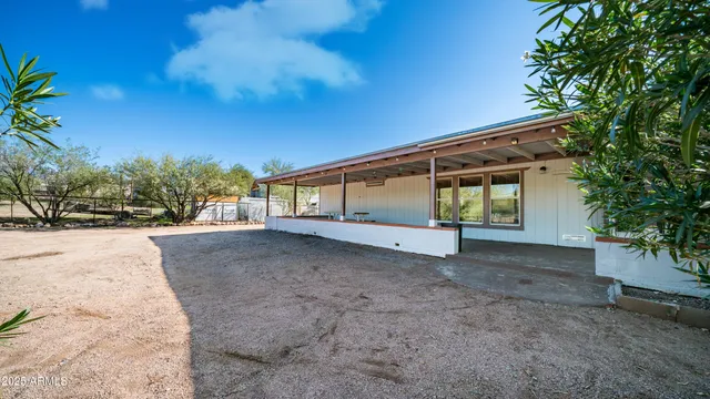 a kitchen with stainless steel appliances kitchen island granite countertop a table and chairs in it
