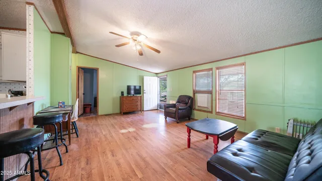 a kitchen with furniture wooden floor and windows