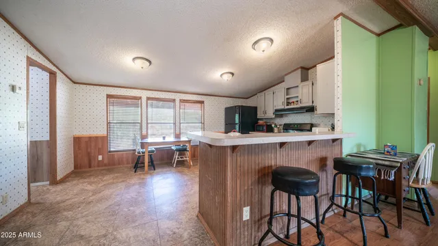a kitchen with stainless steel appliances granite countertop a sink and cabinets