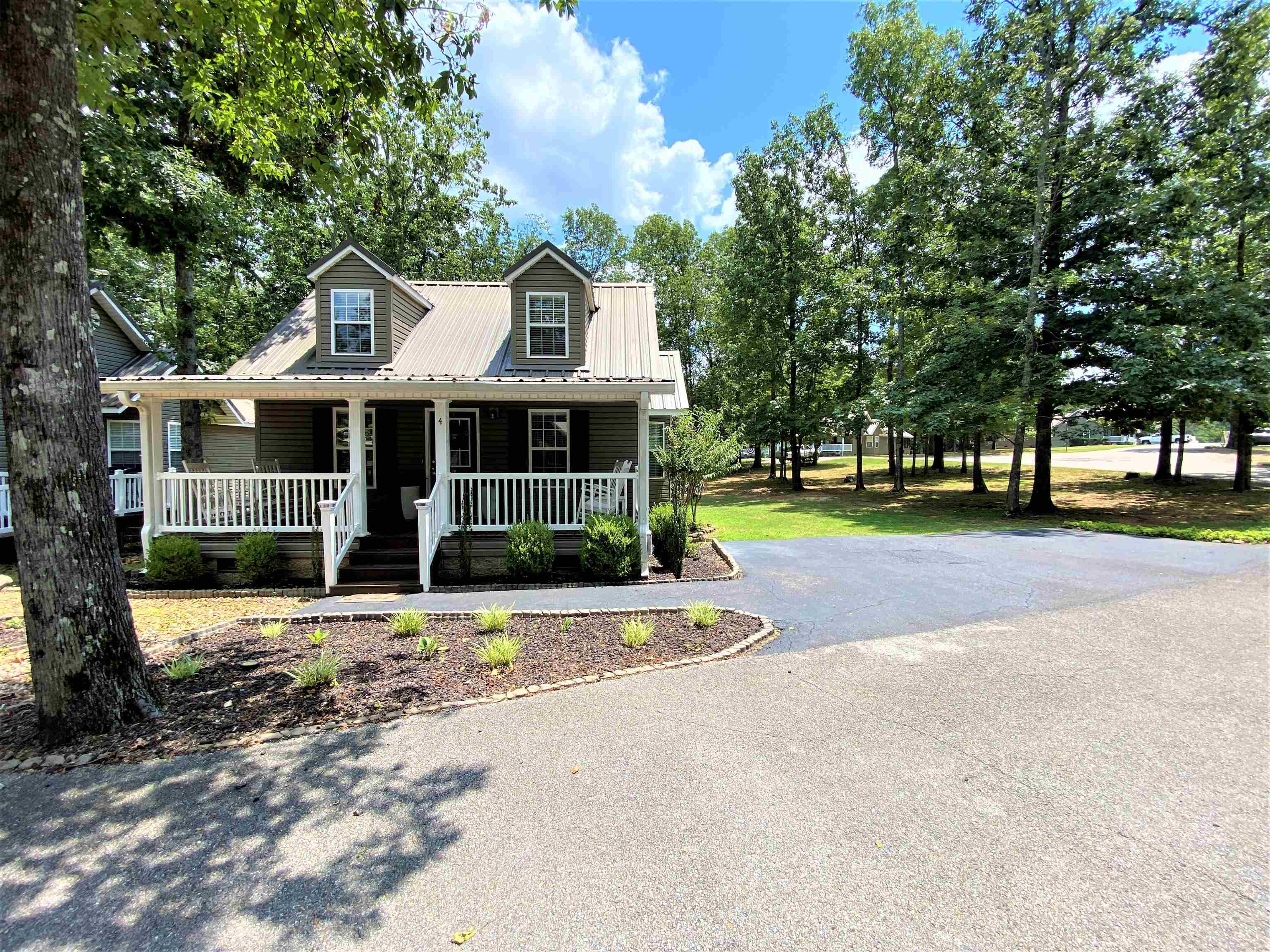4 Patsy Path Iuka, MS 38852 - Photo 23 of 25 a view of a white house with a large windows and large trees