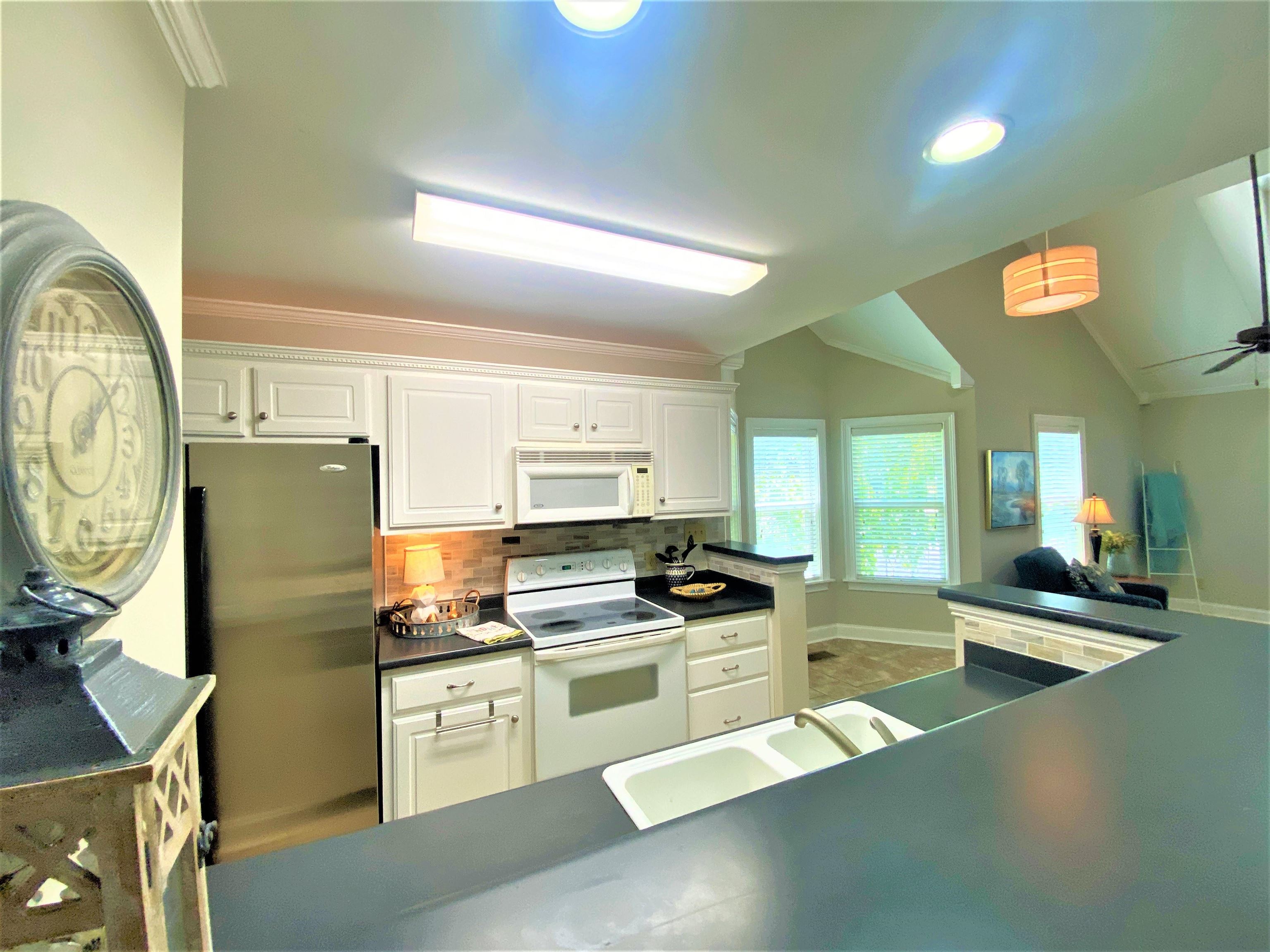 4 Patsy Path Iuka, MS 38852 - Photo 9 of 25 a kitchen with stainless steel appliances a stove a sink a refrigerator white cabinets and wooden floor
