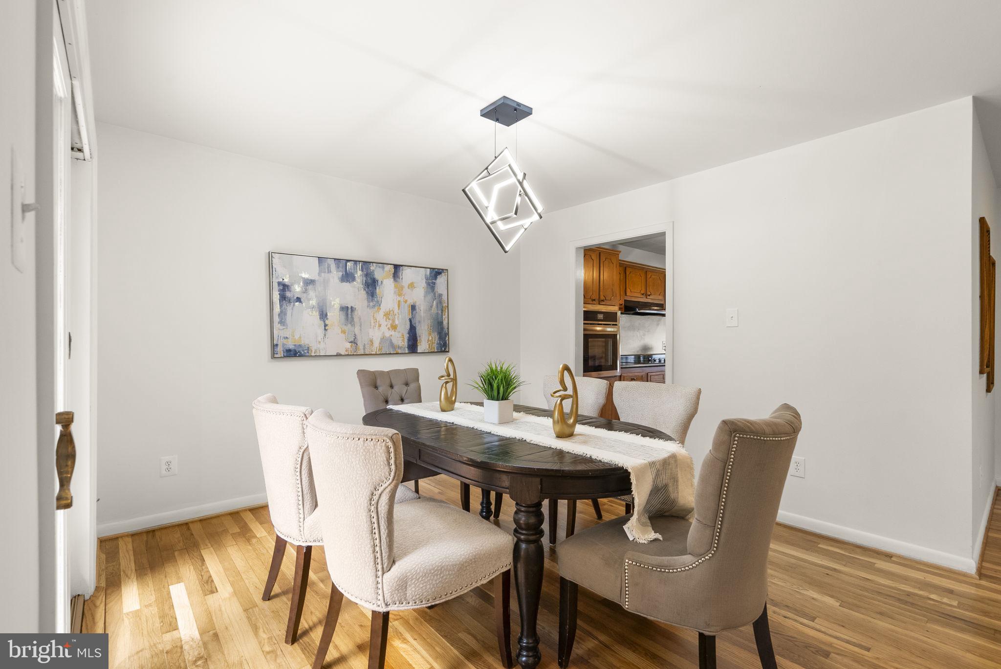 1503 Leister Drive Silver Spring, MD 20904 - Photo 13 of 58 a dining room with furniture a rug and wooden floor