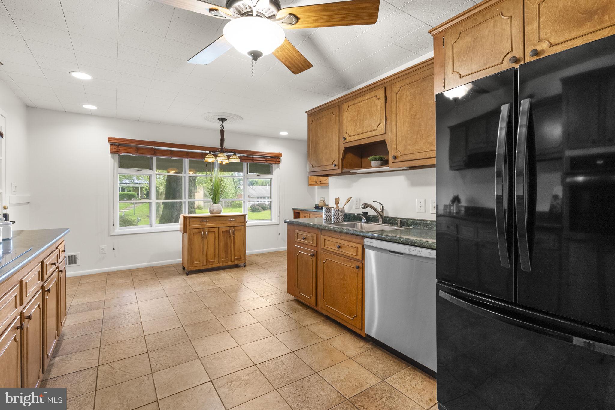 1503 Leister Drive Silver Spring, MD 20904 - Photo 16 of 58 a kitchen with stainless steel appliances granite countertop a refrigerator a sink dishwasher a stove and white cabinets with wooden floor