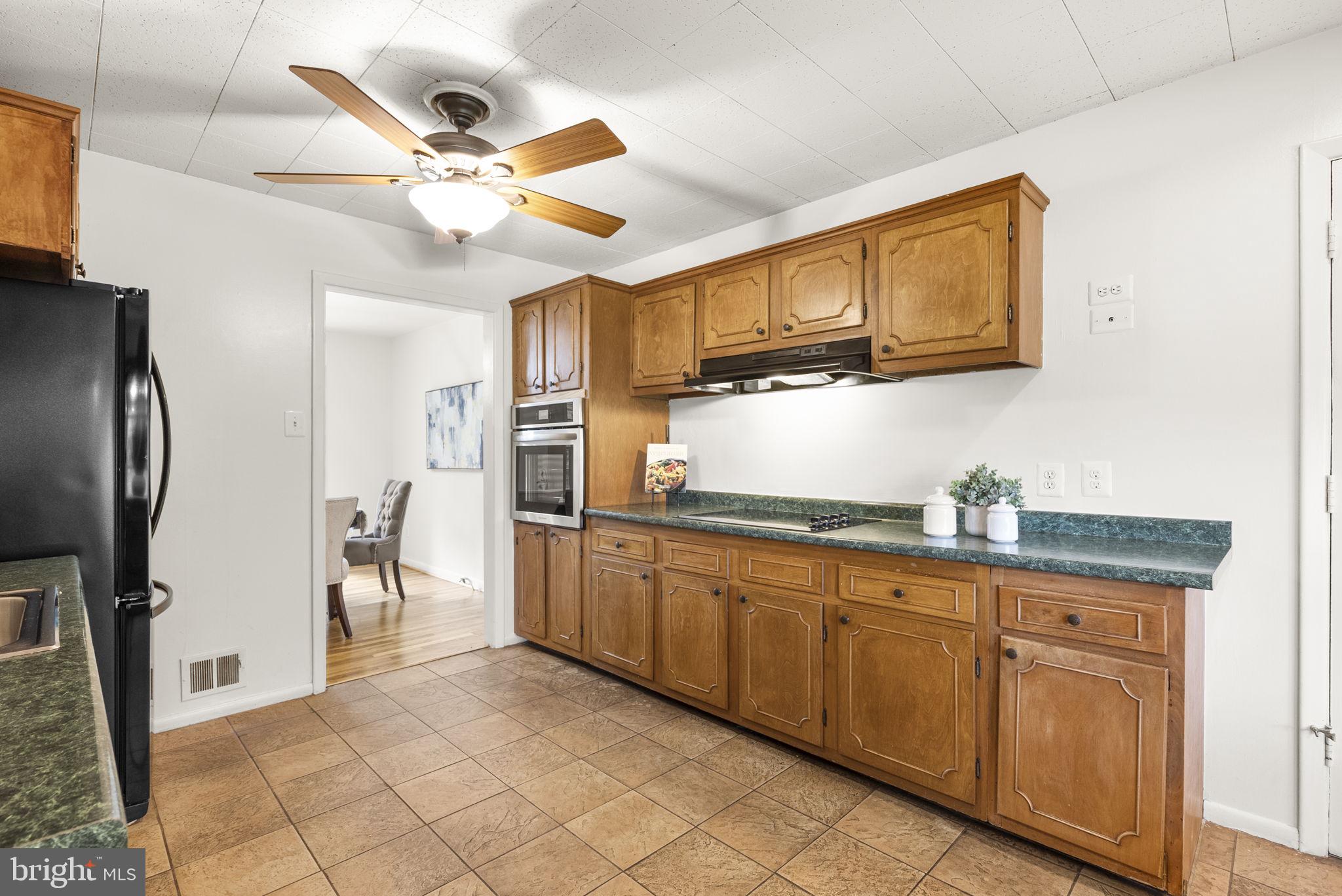 1503 Leister Drive Silver Spring, MD 20904 - Photo 19 of 58 a kitchen with stainless steel appliances granite countertop a sink and a refrigerator