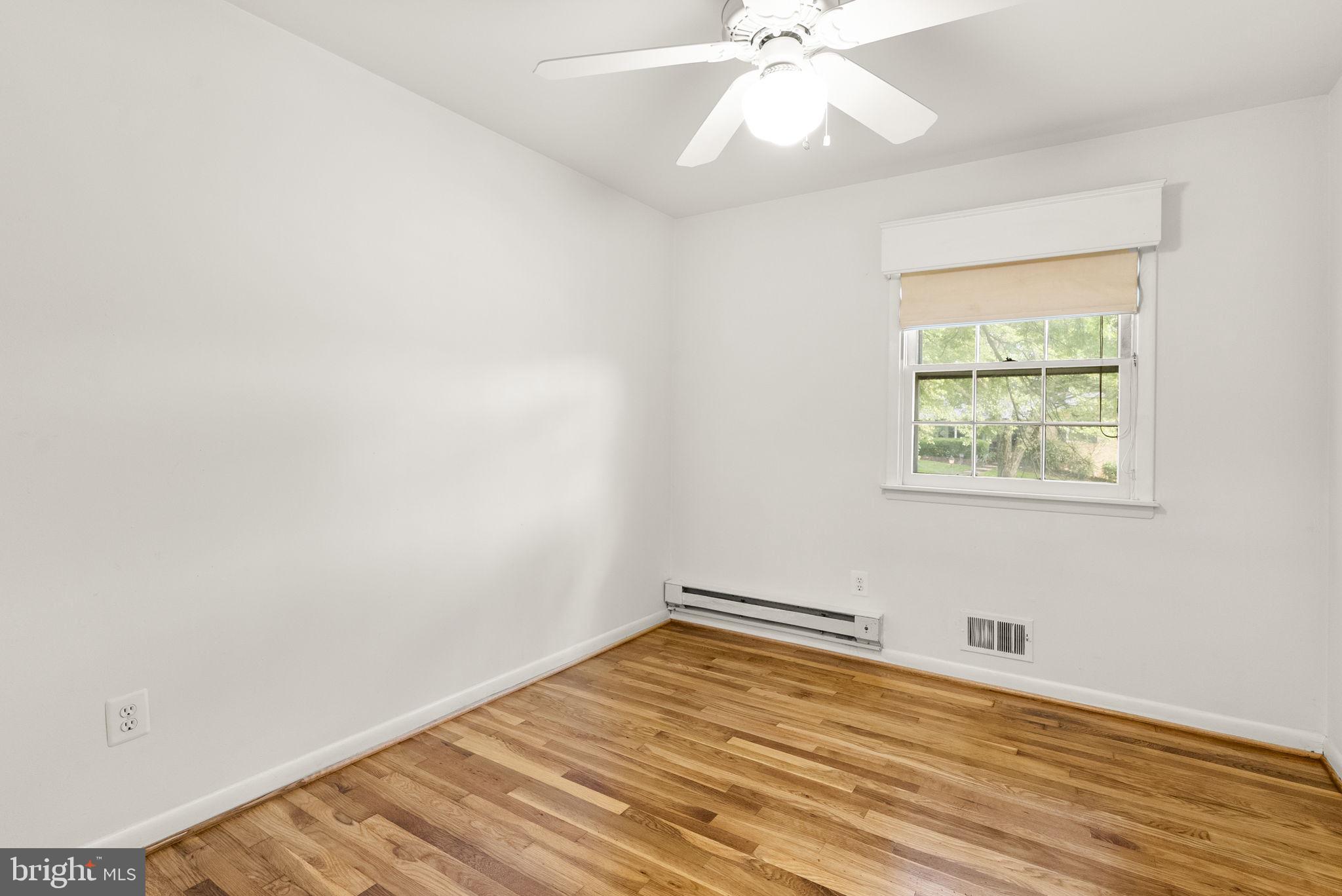 1503 Leister Drive Silver Spring, MD 20904 - Photo 32 of 58 an empty room with a window and wooden floor