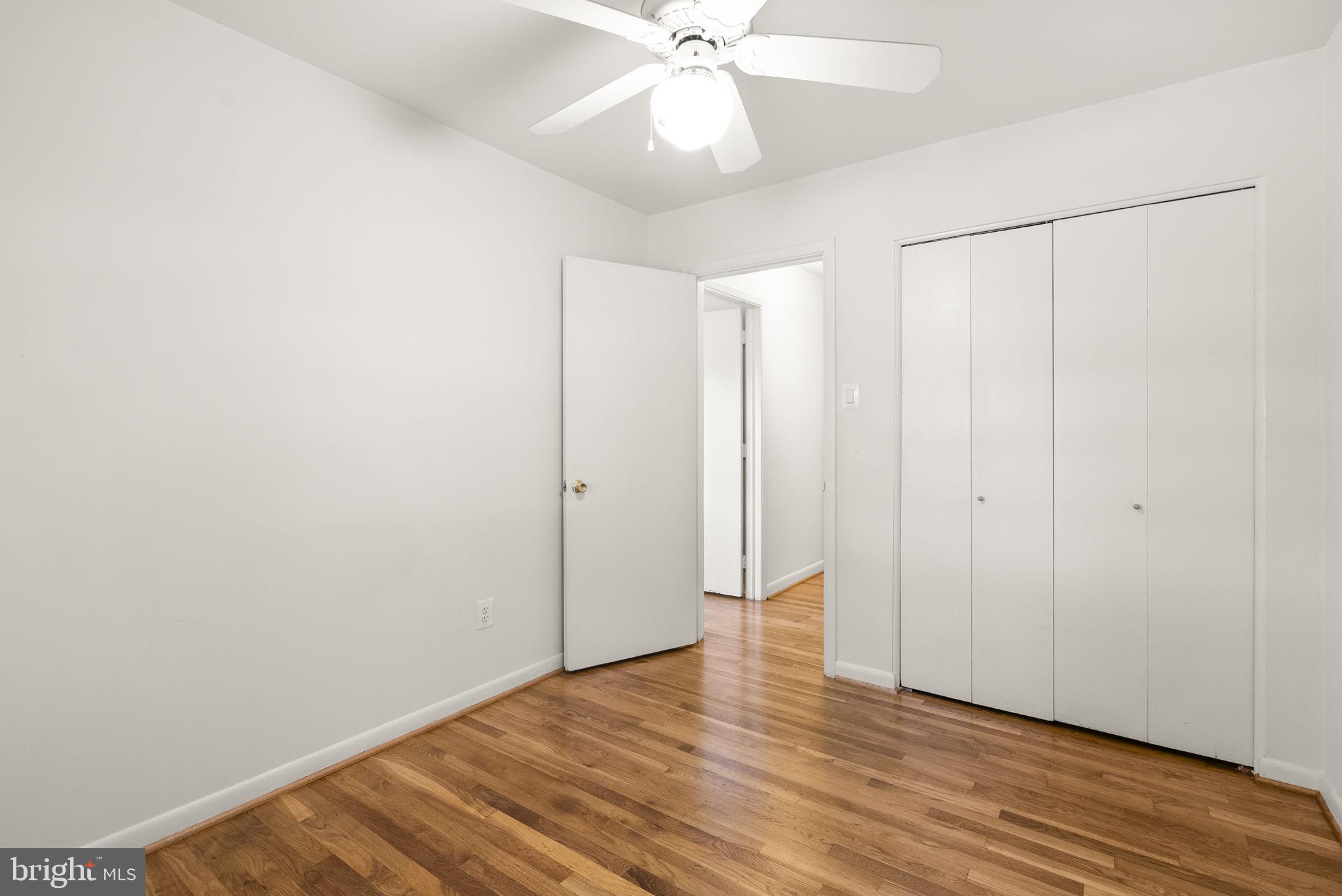 1503 Leister Drive Silver Spring, MD 20904 - Photo 34 of 58 a view of an empty room with wooden floor and a ceiling fan