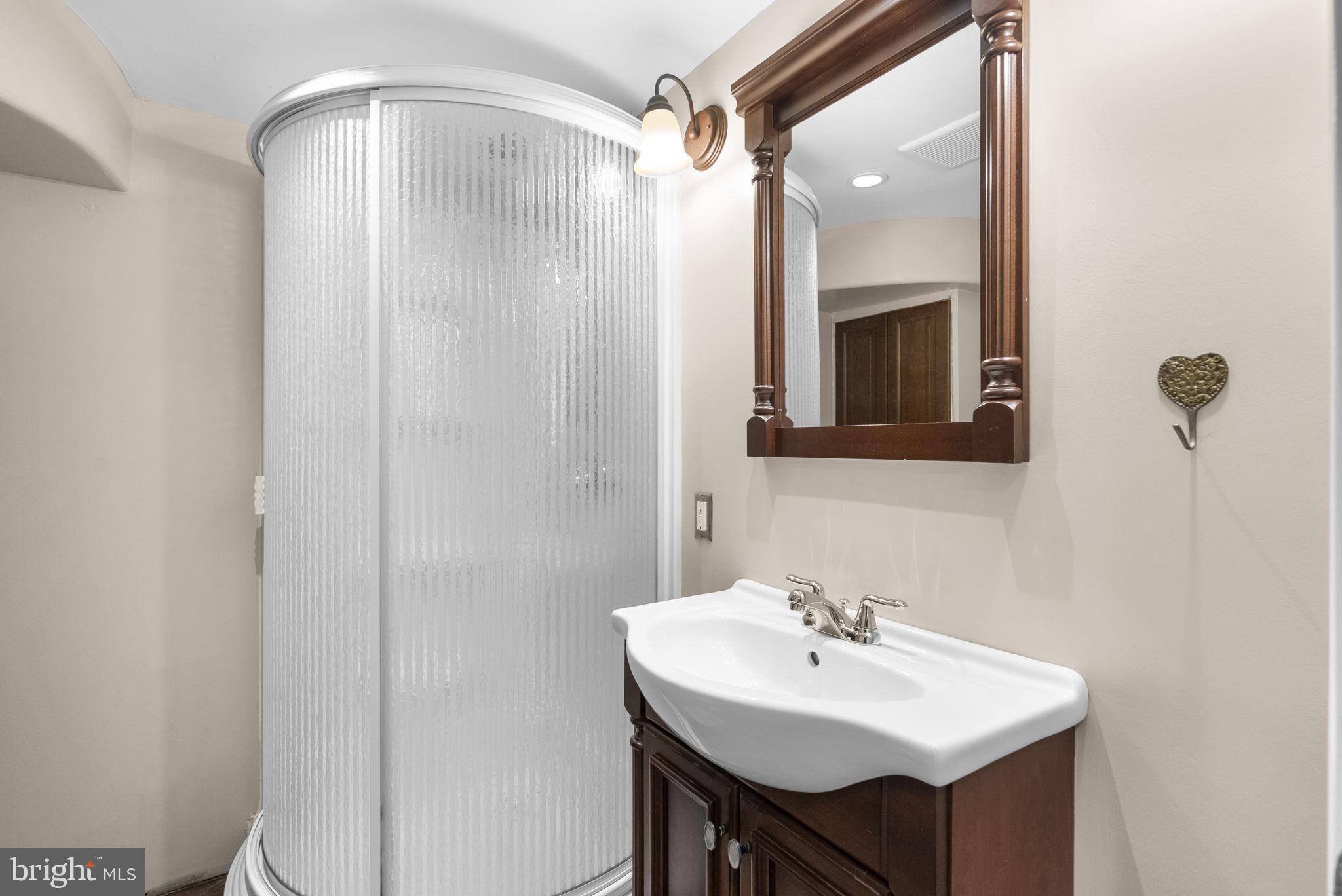 1503 Leister Drive Silver Spring, MD 20904 - Photo 49 of 58 a bathroom with a sink a mirror and a shower