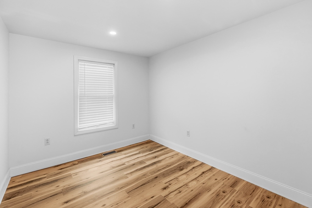 8 Cottage Street Wareham, MA 02571 - Photo 13 of 30 an empty room with wooden floor and windows