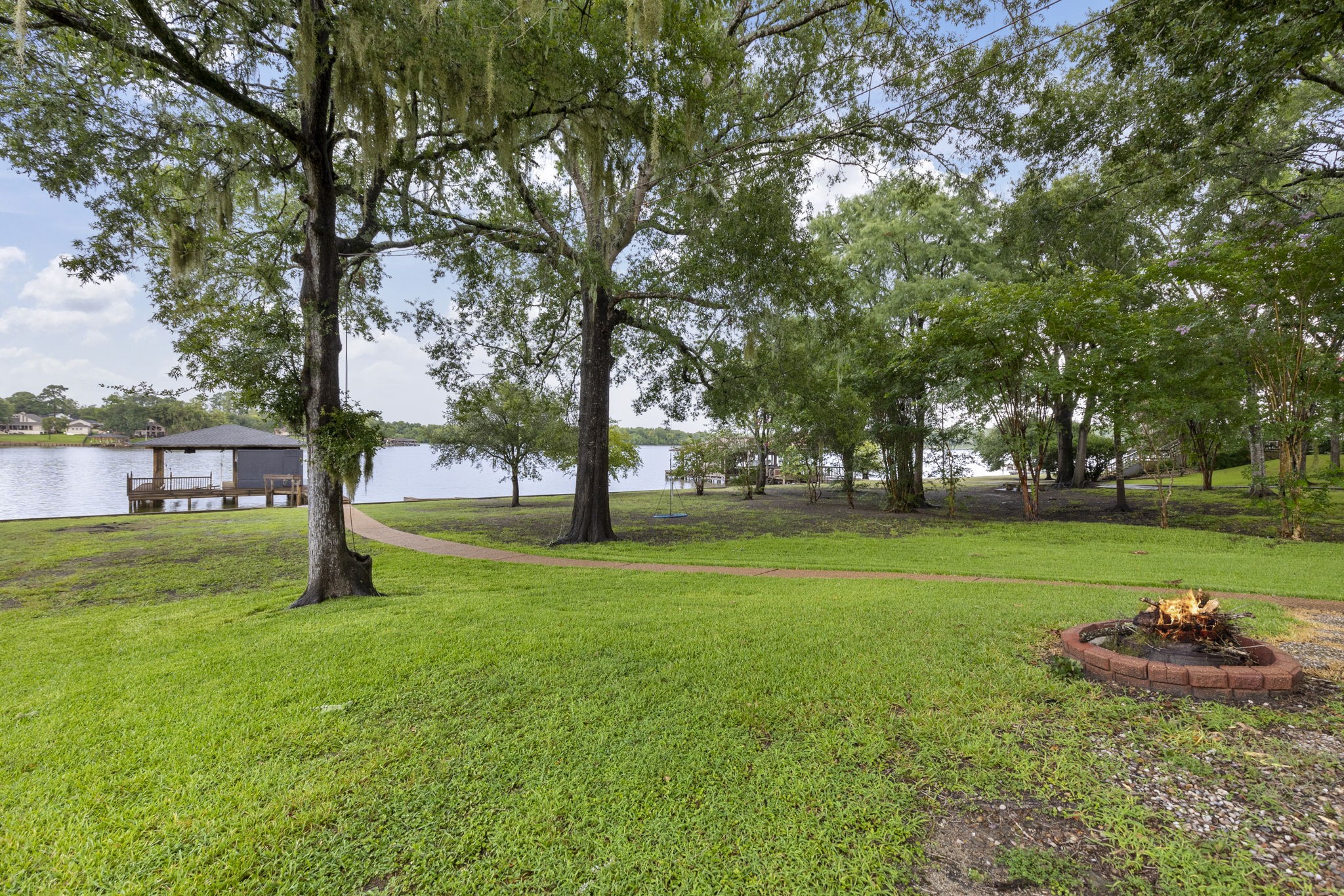 245 Lakeland Road Huntsville, TX 77320 - Photo 43 of 49 Relax and enjoy the evenings by the backyard firepit, offering breathtaking views of the lake