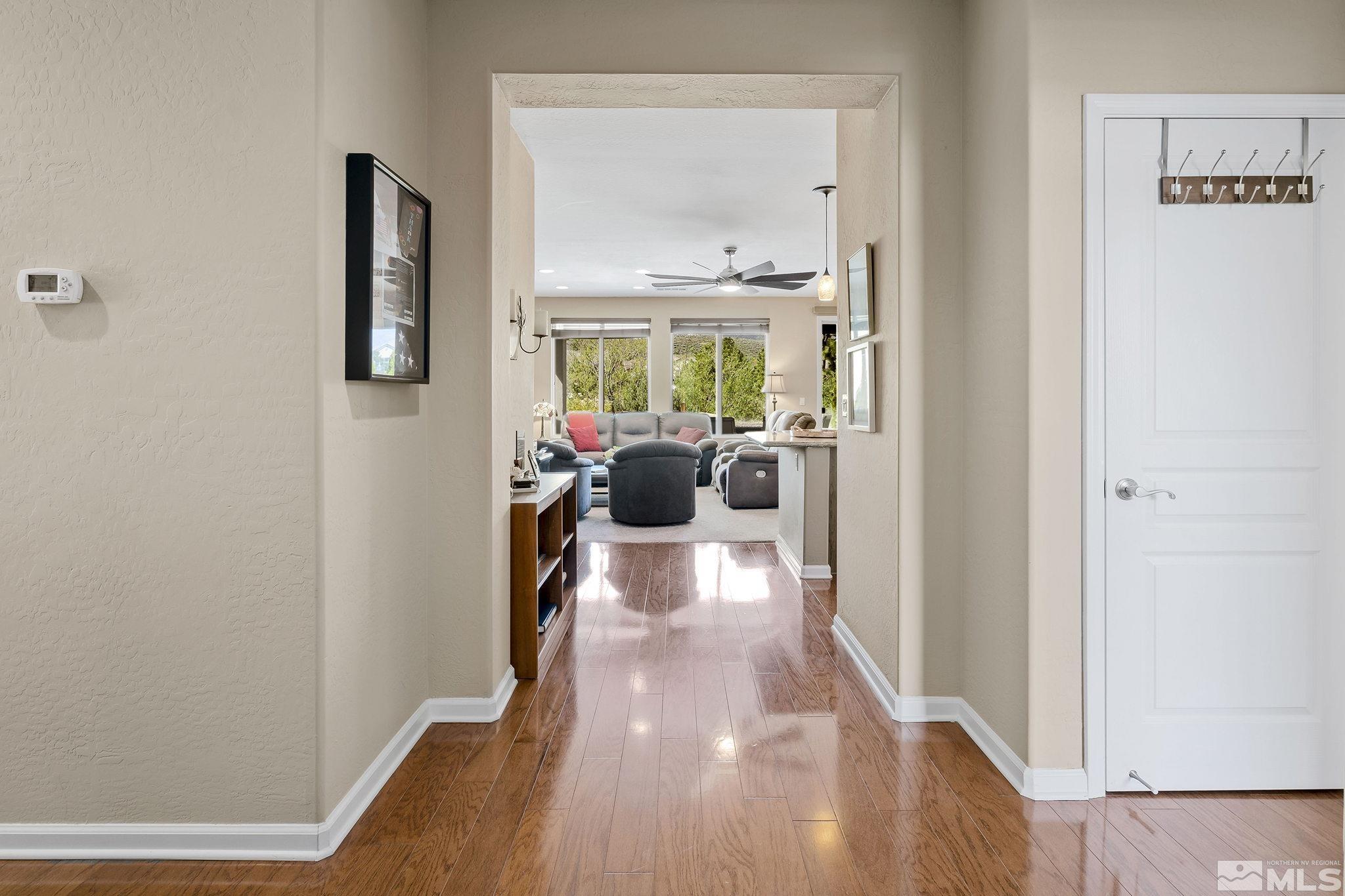 1395 Meridian Ranch Drive Reno, NV 89523 - Photo 3 of 24 a view of a hallway with wooden floor and furniture