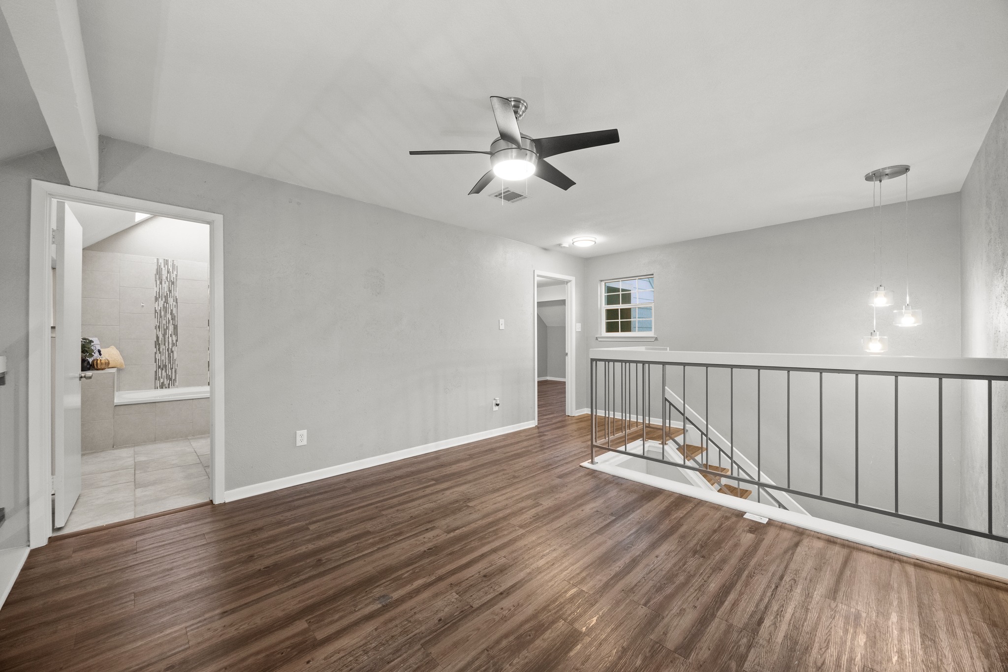 8330 Fathom Circle, Unit 501 Austin, TX 78750 - Photo 15 of 26 an empty room with wooden floor fan and windows