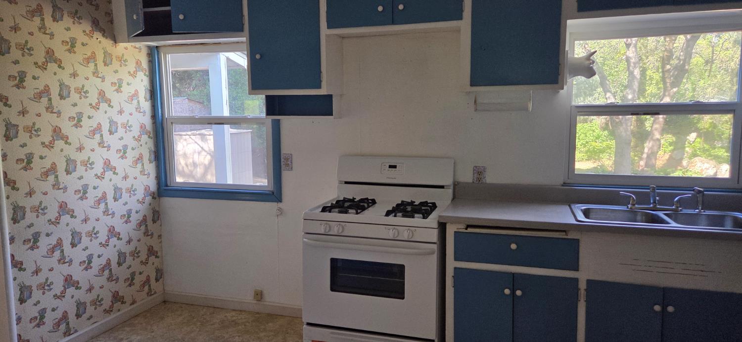 1661 Taylor Road Penryn, CA 95663 - Photo 12 of 16 a kitchen with a sink stove and cabinets