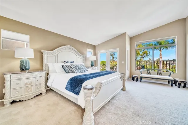 a spacious bedroom with a bed and a large window