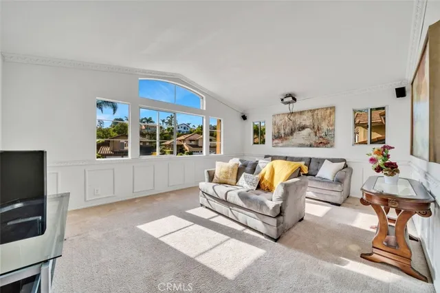 a living room with furniture a window and a flat screen tv