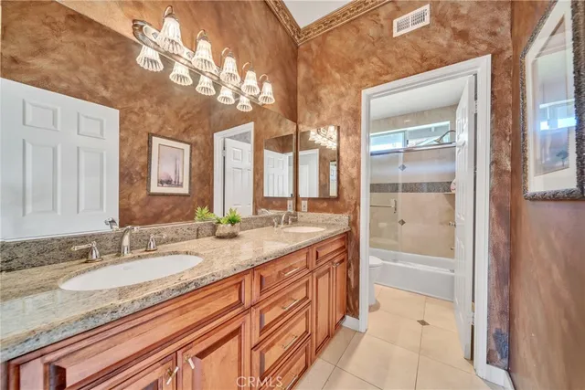 a bathroom with a granite countertop sink mirror and bathtub
