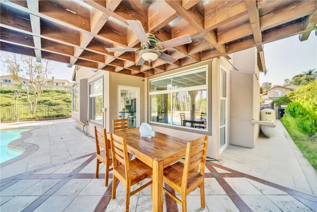 a view of a patio with a table and chairs and potted plants