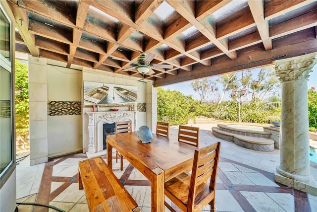 a view of a dining room with furniture a chandelier and wooden floor