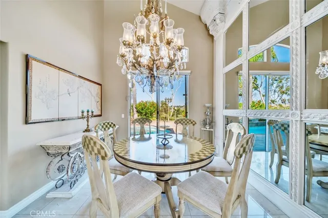 a view of a dining room with furniture and chandelier
