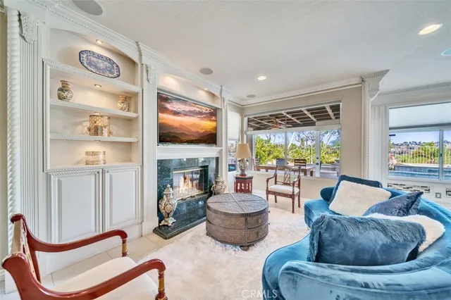 a living room with furniture a fireplace and a flat screen tv