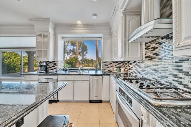 a kitchen with stainless steel appliances a sink stove and cabinets