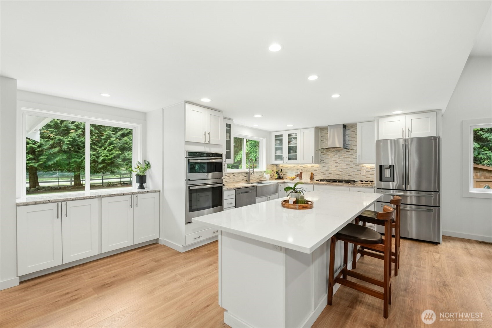 23307 49th Avenue Southeast Bothell, WA 98021 - Photo 9 of 37 a kitchen with white cabinets and stainless steel appliances