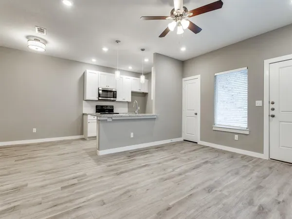 a view of a room with wooden floor