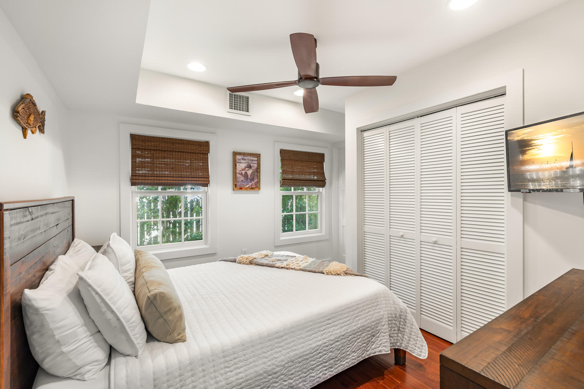 1311 Pine Street Key West, FL 33040 - Photo 15 of 25 a bedroom with a bed and a flat tv screen on dresser