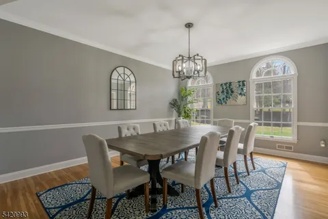 a view of a dining room with furniture and chandelier