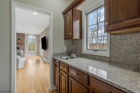 a kitchen with a dining table chairs and white cabinets