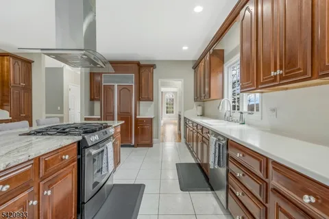 a kitchen with stainless steel appliances a stove a sink and a refrigerator