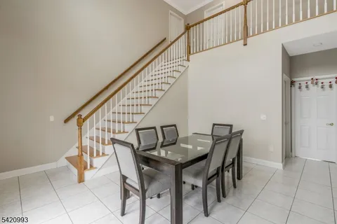 a view of a dining room with furniture and a window