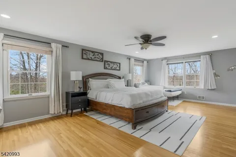 a bedroom with a large bed and a chandelier