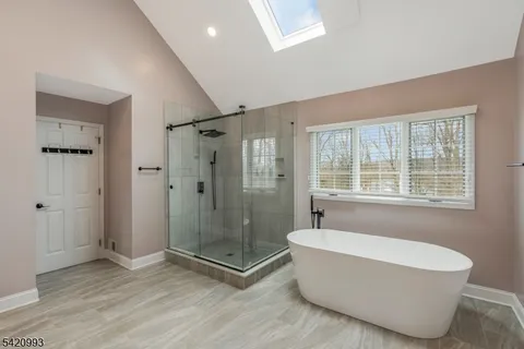 a spacious bathroom with a granite countertop sink and a mirror