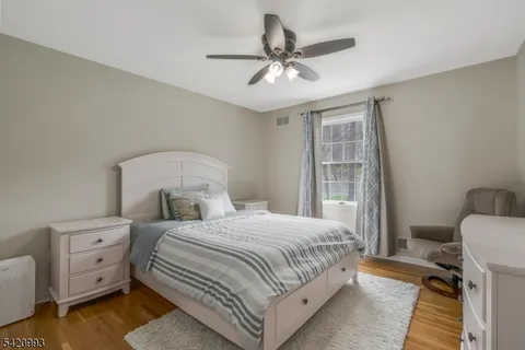 a bathroom with a granite countertop sink a light fixture and a mirror