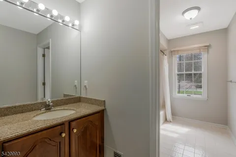 a view of staircase with railing and a chandelier