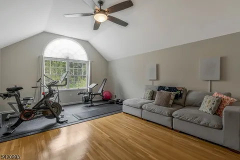 a bedroom with a bed and a flat tv screen on the dresser