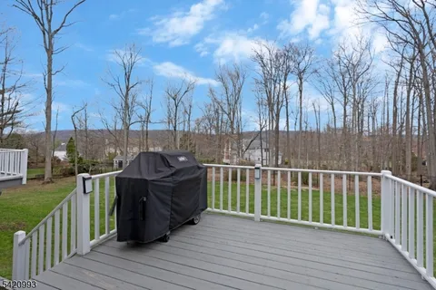 a roof deck with couches and wooden fence