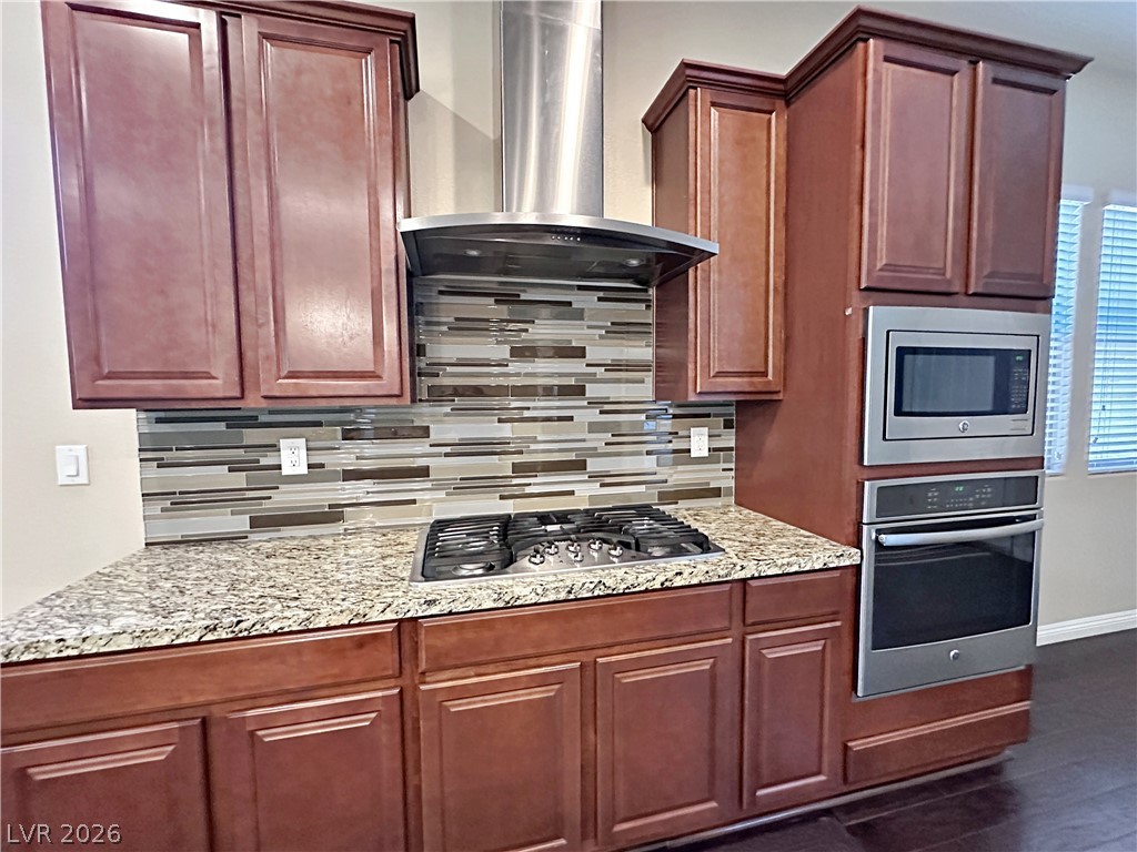 71 Newton Ridge Way Las Vegas, NV 89183 - Photo 15 of 40 Culinary delights await in this sleek kitchen featuring premium appliances and elegant finishes.