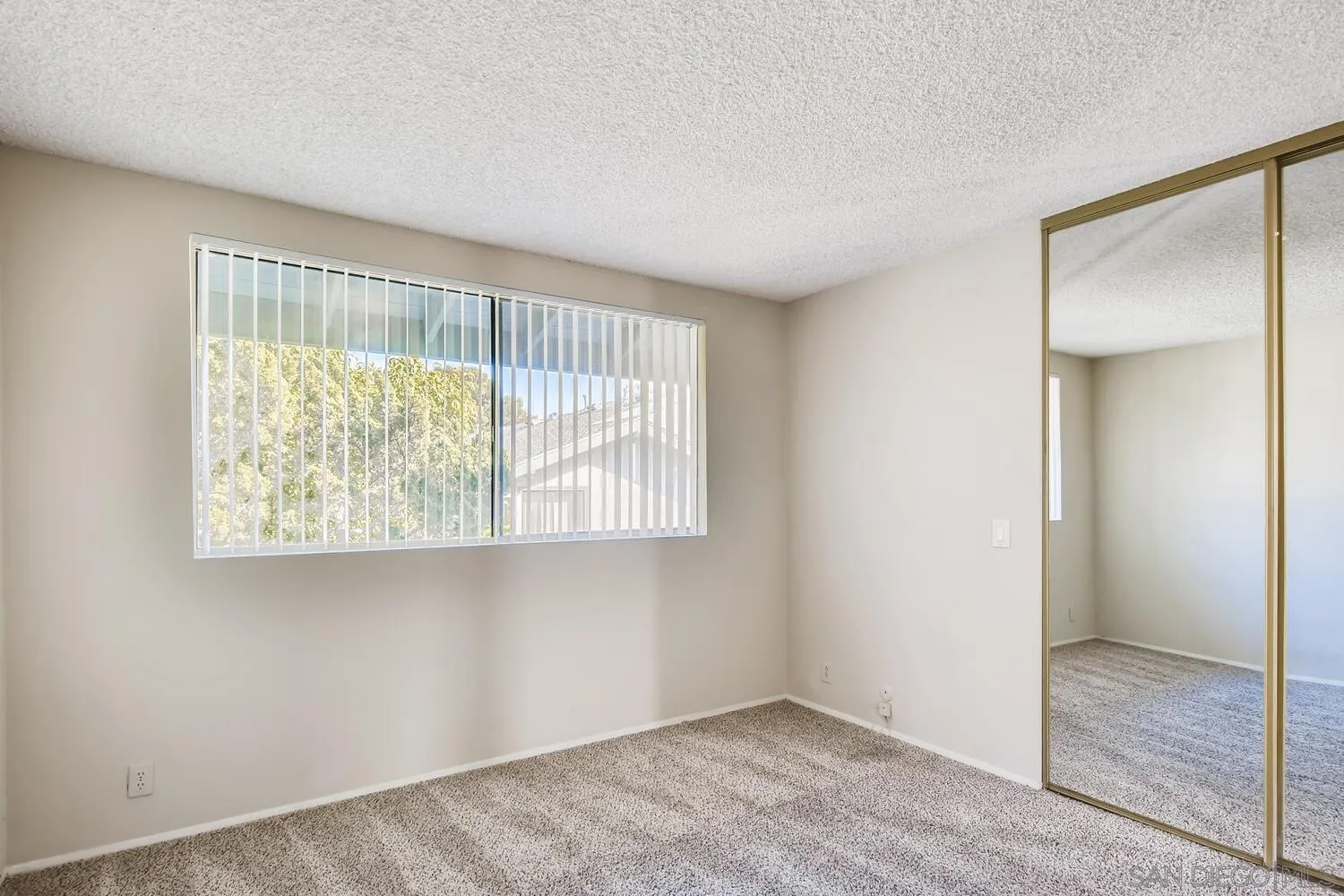 8271 Caminito Modena San Diego, CA 92037 - Photo 12 of 28 a view of an empty room with a window