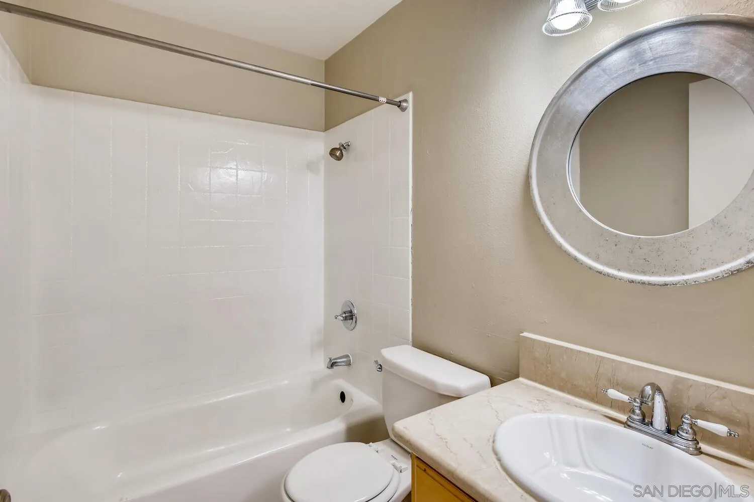 8271 Caminito Modena San Diego, CA 92037 - Photo 16 of 28 a bathroom with a toilet sink a mirror and bathtub