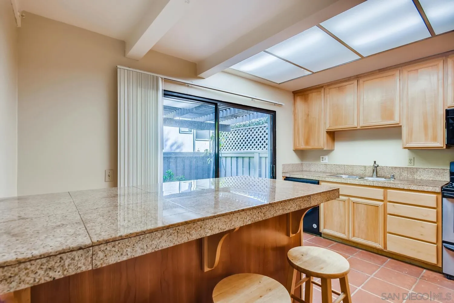 8271 Caminito Modena San Diego, CA 92037 - Photo 22 of 28 a kitchen with a table chairs sink and cabinets