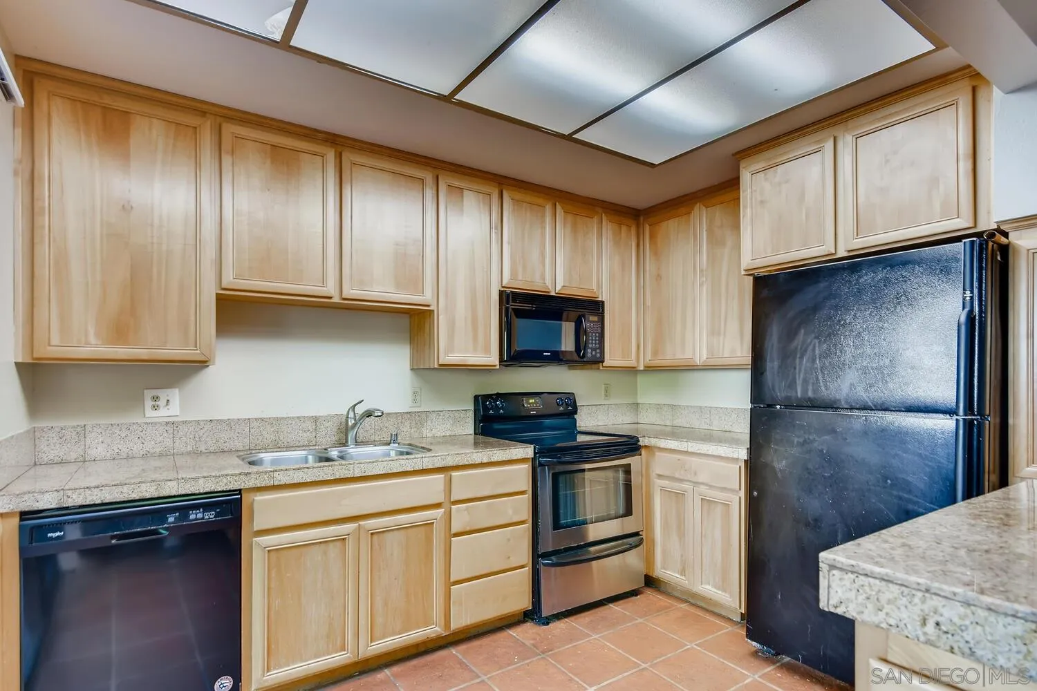 8271 Caminito Modena San Diego, CA 92037 - Photo 25 of 28 a kitchen with granite countertop cabinets stainless steel appliances and a counter space