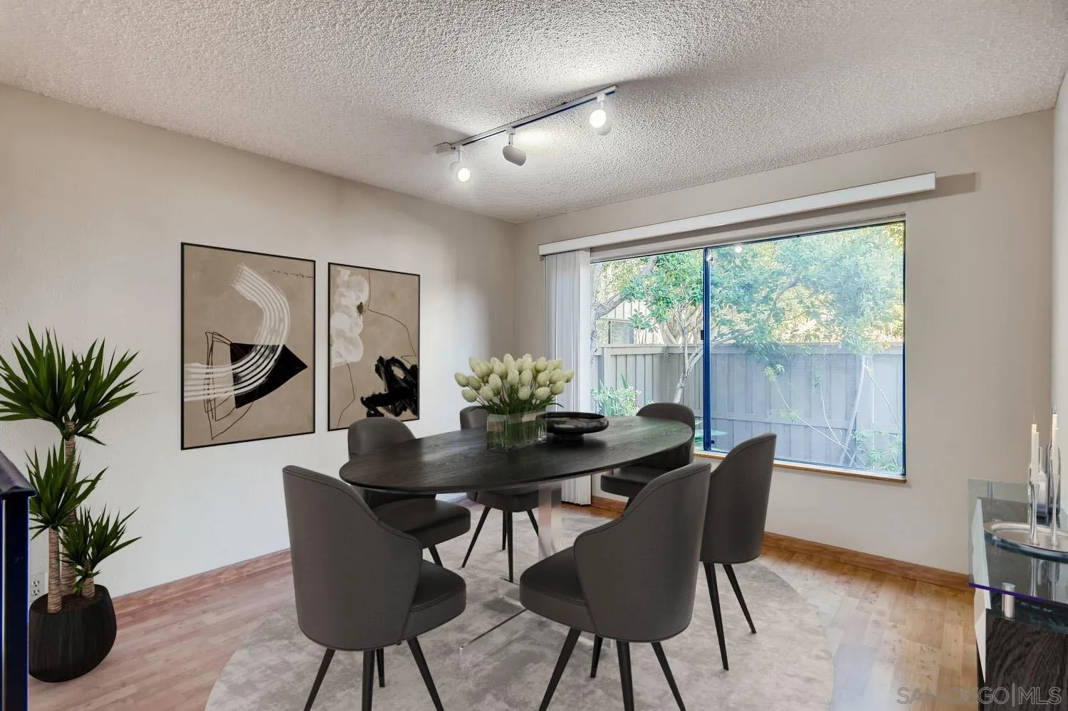 8271 Caminito Modena San Diego, CA 92037 - Photo 3 of 28 a dining room with furniture window and wooden floor