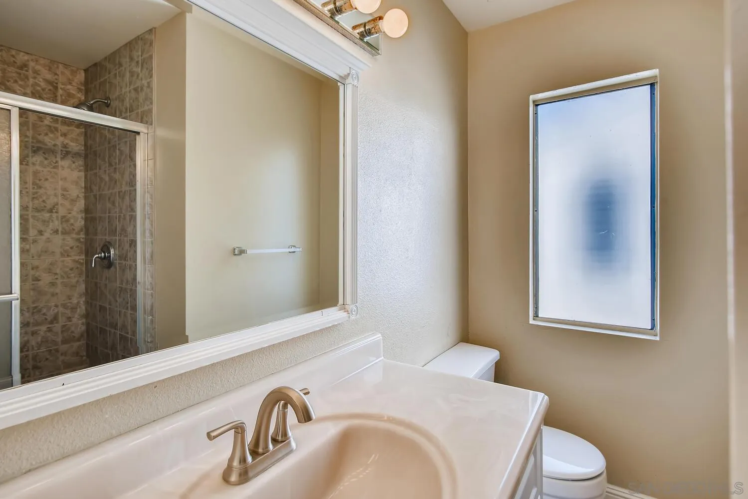 8271 Caminito Modena San Diego, CA 92037 - Photo 9 of 28 a bathroom with a sink and a mirror