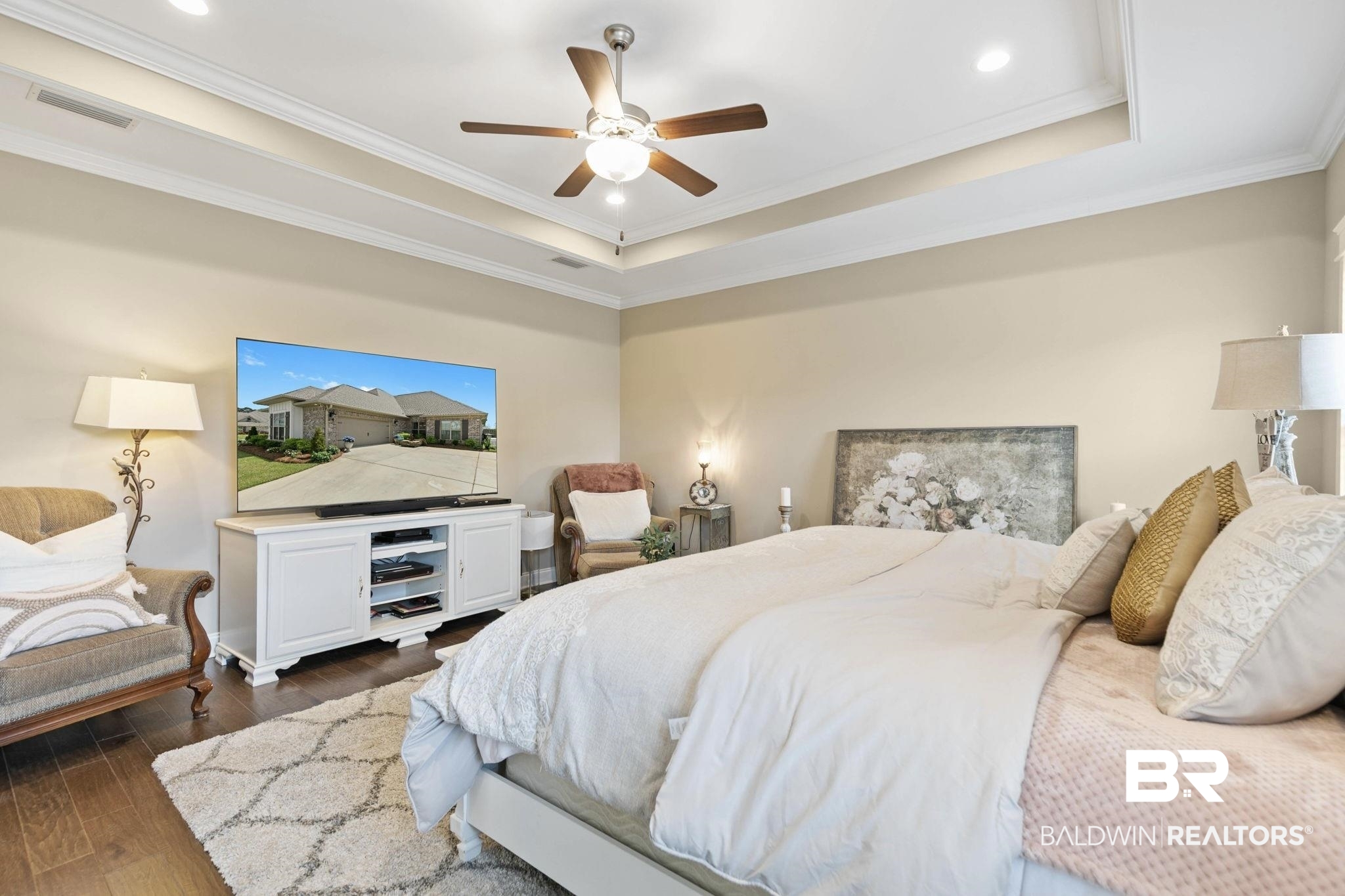 291 Hemlock Drive Fairhope, AL 36532 - Photo 29 of 65 Bedroom featuring dark wood-style flooring, ornamental molding, a tray ceiling, a ceiling fan, and recessed lighting