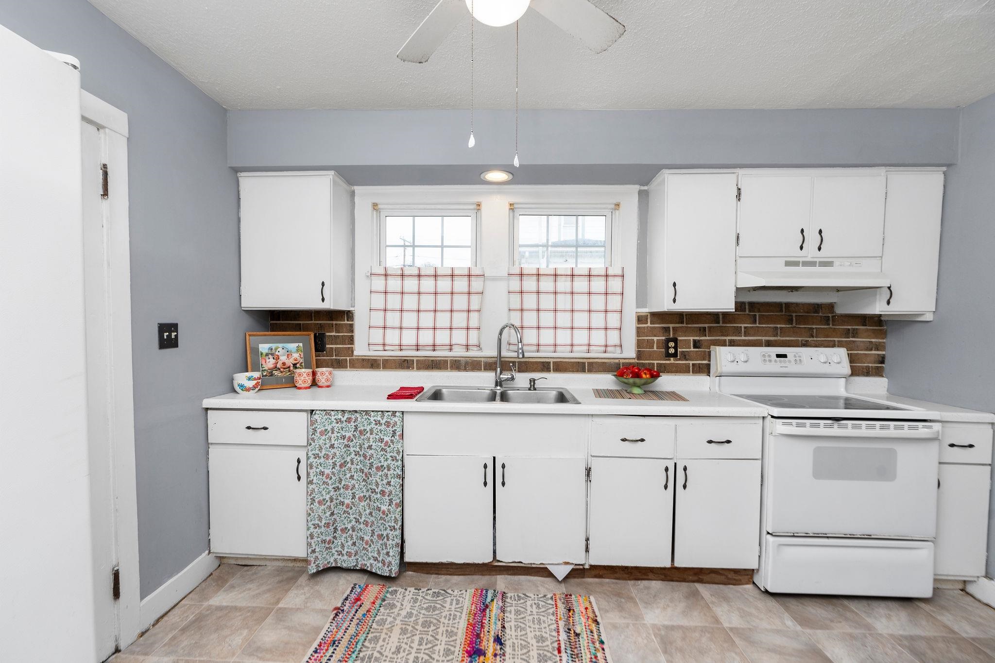 712 Nelson Street Staunton, VA 24401 - Photo 11 of 30 a kitchen with white cabinets sink and window