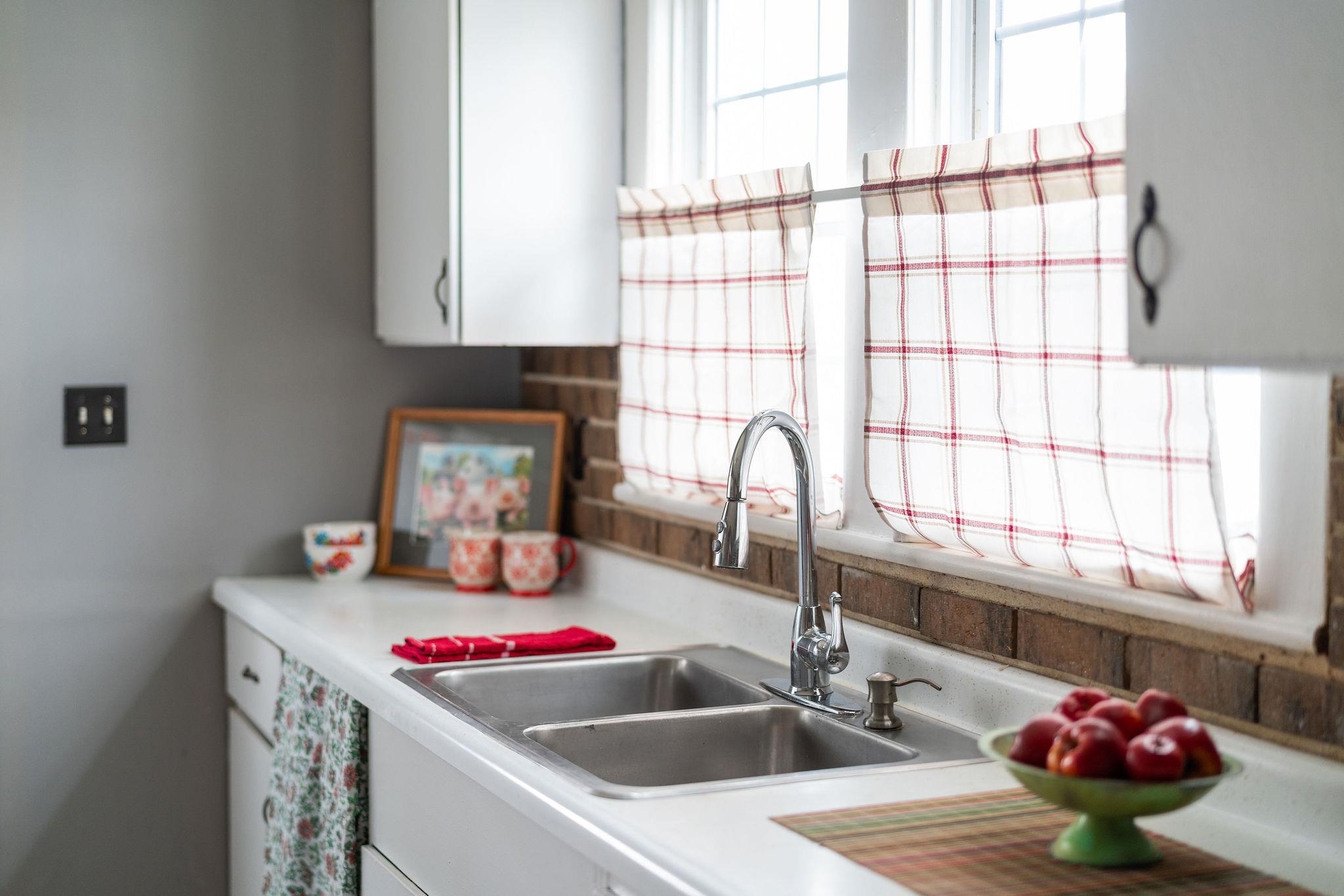 712 Nelson Street Staunton, VA 24401 - Photo 13 of 30 a kitchen with a sink and a stove next to a window