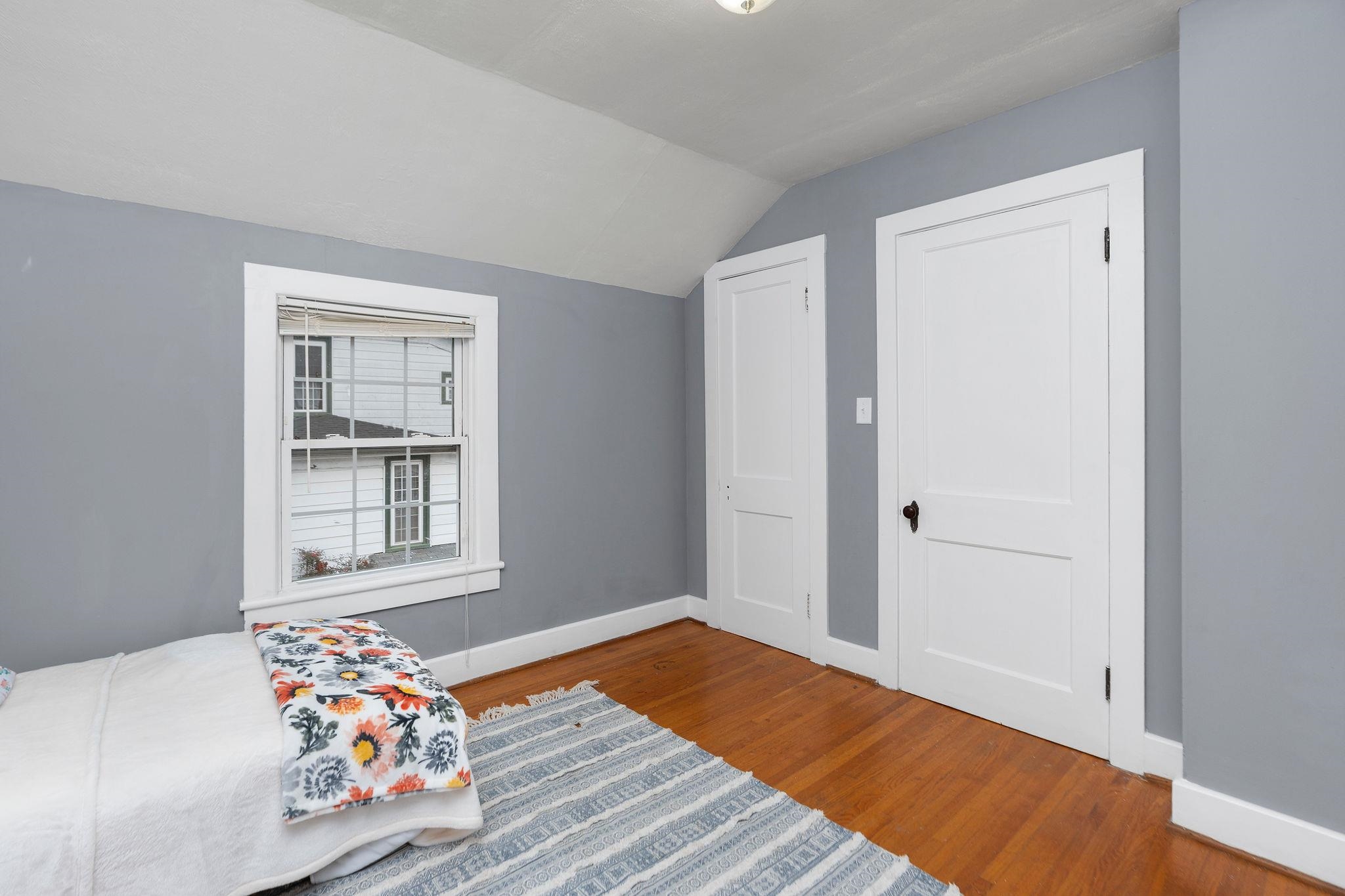 712 Nelson Street Staunton, VA 24401 - Photo 19 of 30 a bedroom with a bed and wooden floor