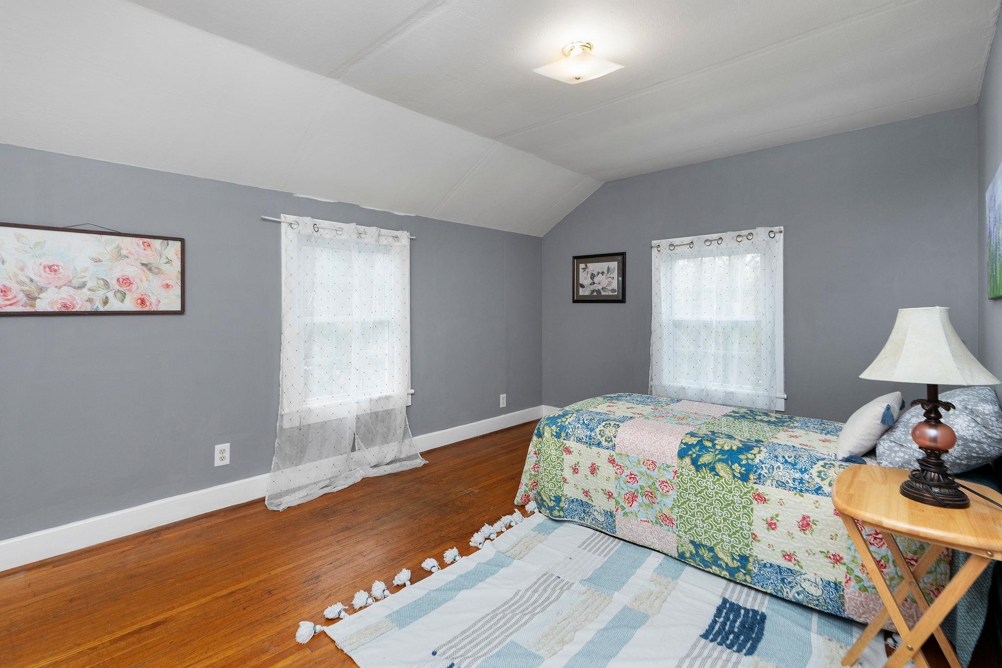 712 Nelson Street Staunton, VA 24401 - Photo 20 of 30 a bedroom with a bed and a lamp on dresser