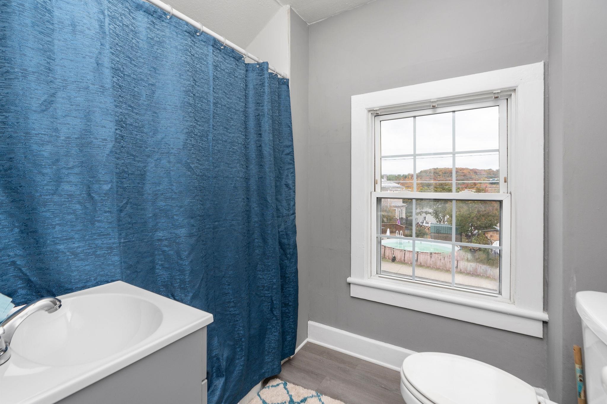 712 Nelson Street Staunton, VA 24401 - Photo 24 of 30 a bathroom with a sink a toilet and a window